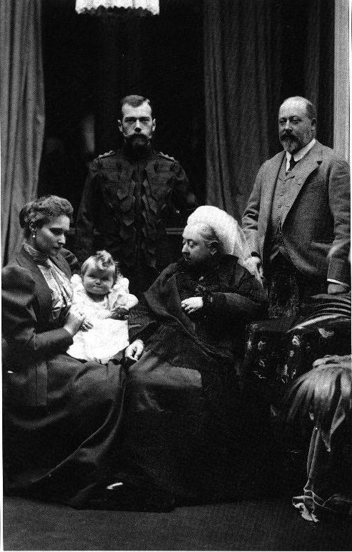 Here, Empress Alexandra (far left) sits with her husband (standing next to her) and her grandmother Queen Victoria (1819-1901, r. 1837-1901) on one of the Imperial couple's many visits to England. To Queen Victoria's left, standing beside her is her son and heir, Edward, Prince of Wales, the future Edward VII (r. 1901-1910).